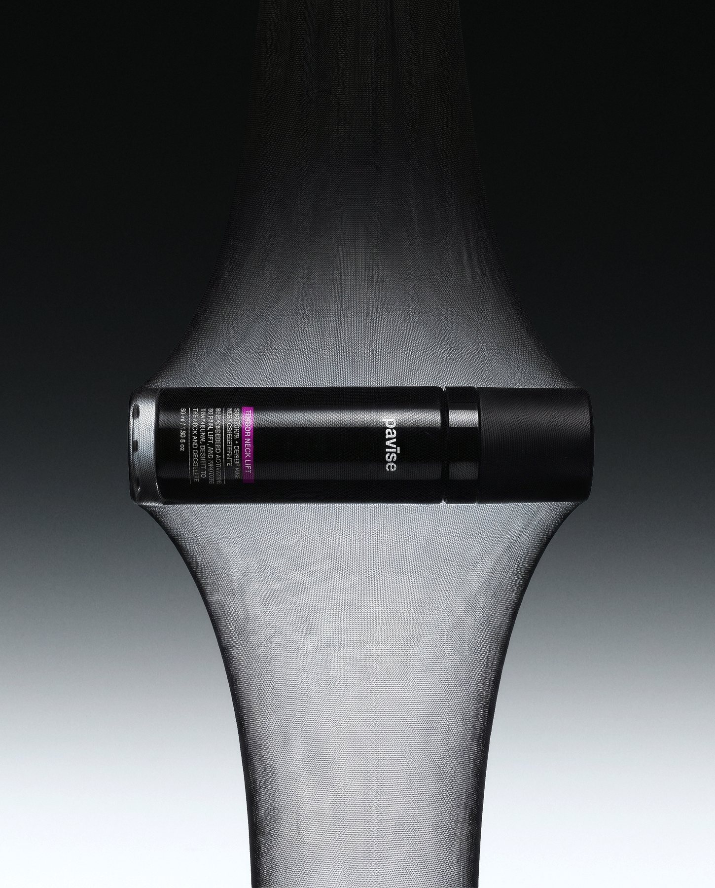 Pavise Tensor Neck Lift bottle held in stretched sheer fabric, a visual of tensile strength for neck skin